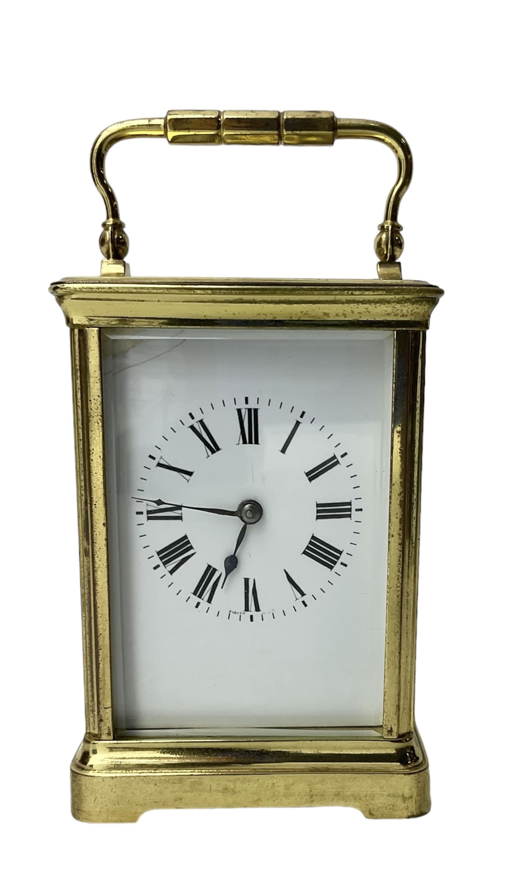 20th century -  8-day striking carriage clock in a corniche case, with an enamel dial , Roman numerals, minute track and steel spade hands, twin train going barrel movement with a lever platform escapement and rack striking, sounding the hours and half hours on a coiled gong.  With key.