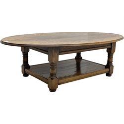 Traditional oak coffee table, moulded oval top, four turned pillar supports united by undertier