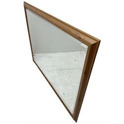Large pine framed wall mirror, rectangular bevelled plate (104cm x 134cm); with another similar (74cm x 104cm)