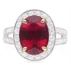 18ct white gold oval cut rubellite tourmaline and round brilliant cut diamond cluster ring, with diamond set shoulders, hallmarked, rubellite 3.93 carat, total diamond weight 0.86 carat 