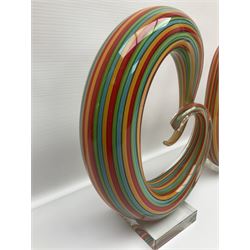 Three art glass sculpture, coiled form with multicolour stranded, upon clear glass plinth, unsigned, largest H27cm