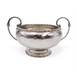 Early 20th century silver twin handled bowl, of plain bellied form with bead and dart rim and two C scroll handles, upon a circular foot, hallmarked Walker & Hall, Sheffield 1919, including handles H9.5cm