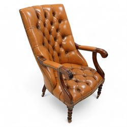 Georgian design mahogany framed library reading chair, upholstered in buttoned tan leather...