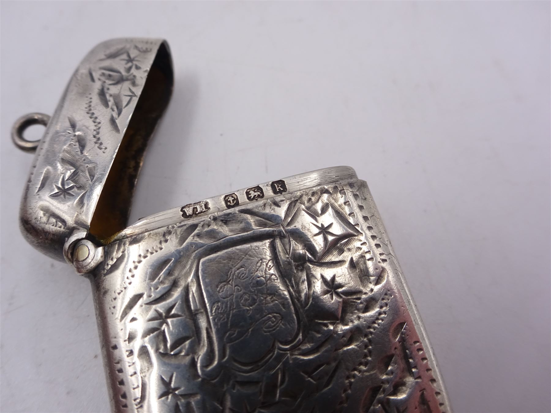 Seven early 20th century silver vesta cases, all of typical form, engraved with foliate and scrolling details, all hallmarked