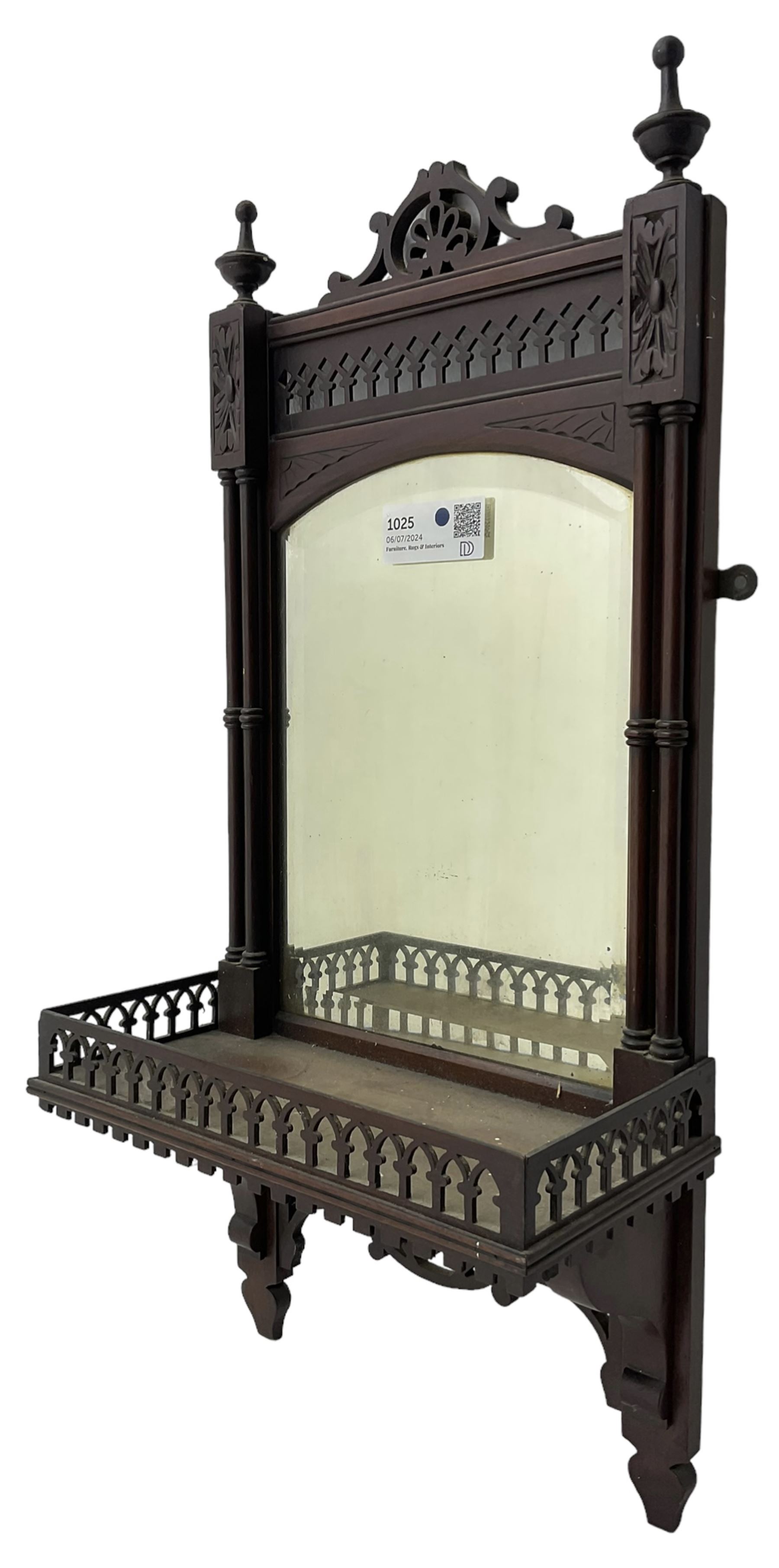 Early 20th century mahogany hall mirror with shelf, pierced pediment flanked by turned finials, the bevelled mirror plate enclosed by turned upright pillars, the shelf with fret work gallery, pierced lattice work lower panel 