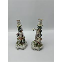 Pair of Derby figural candlesticks, modelled as Venus & Cupid and Mars, Mars wears armour with a shield to his right, Venus dressed in a robe with floral decoration and Cupid by her side, both with pierced sconces above bocage stems, on scrolling raised bases, unmarked, H27cm max (2)