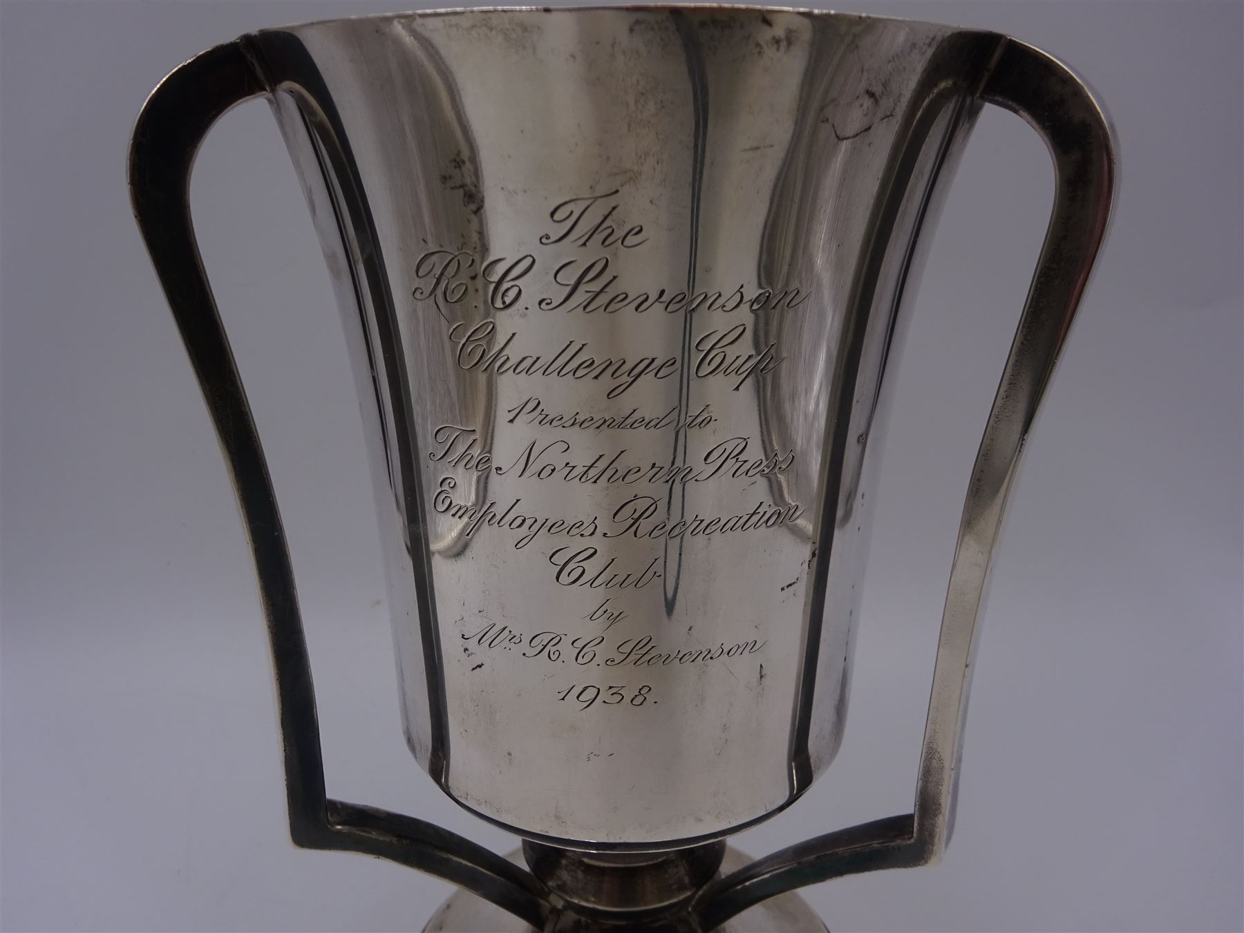 1930s silver three handled trophy, the tapering body inscribed with presentation engraving, upon stepped circular foot, hallmarked Grant & Son, Birmingham 1935, H22cm