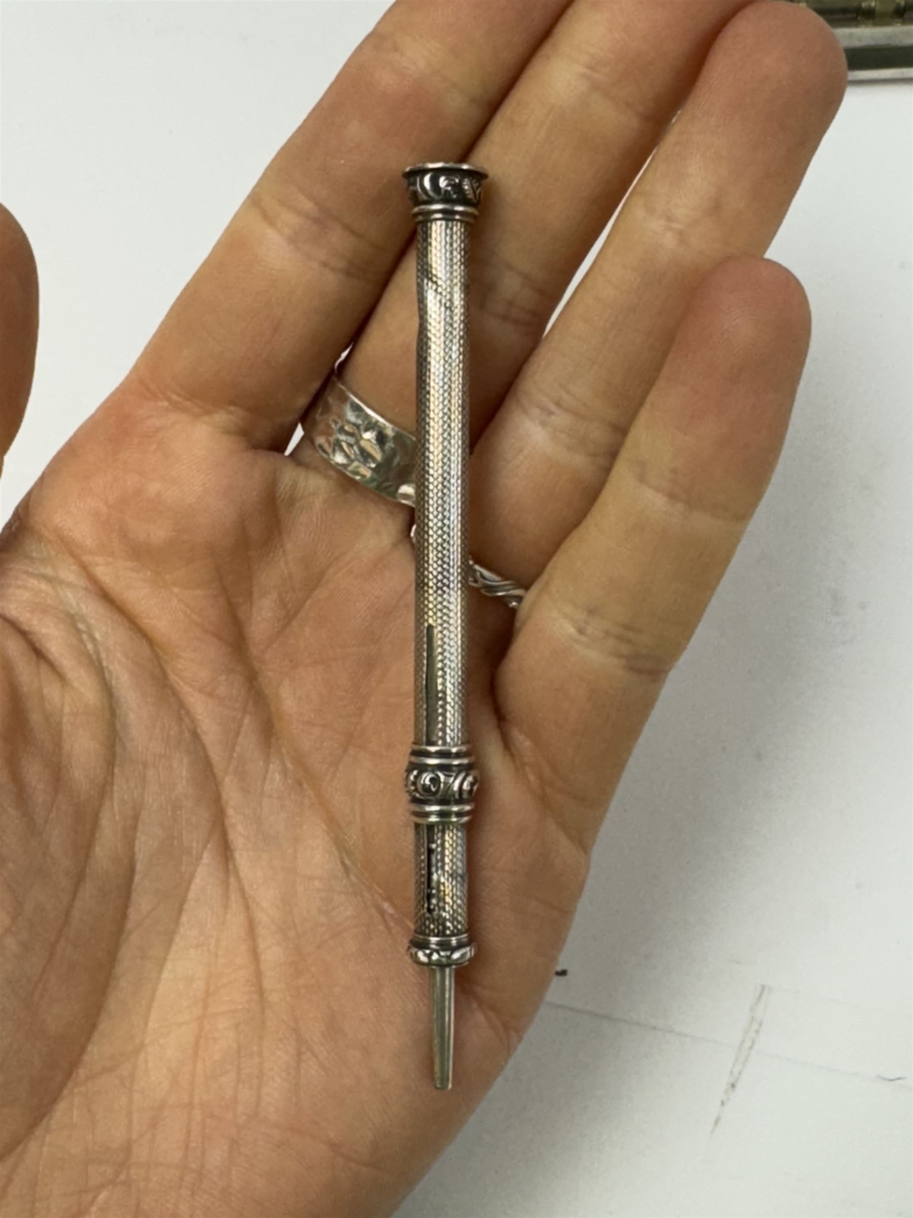 Five mechanical pencils including silver plated examples, together with a collagraphy pen with silver collar