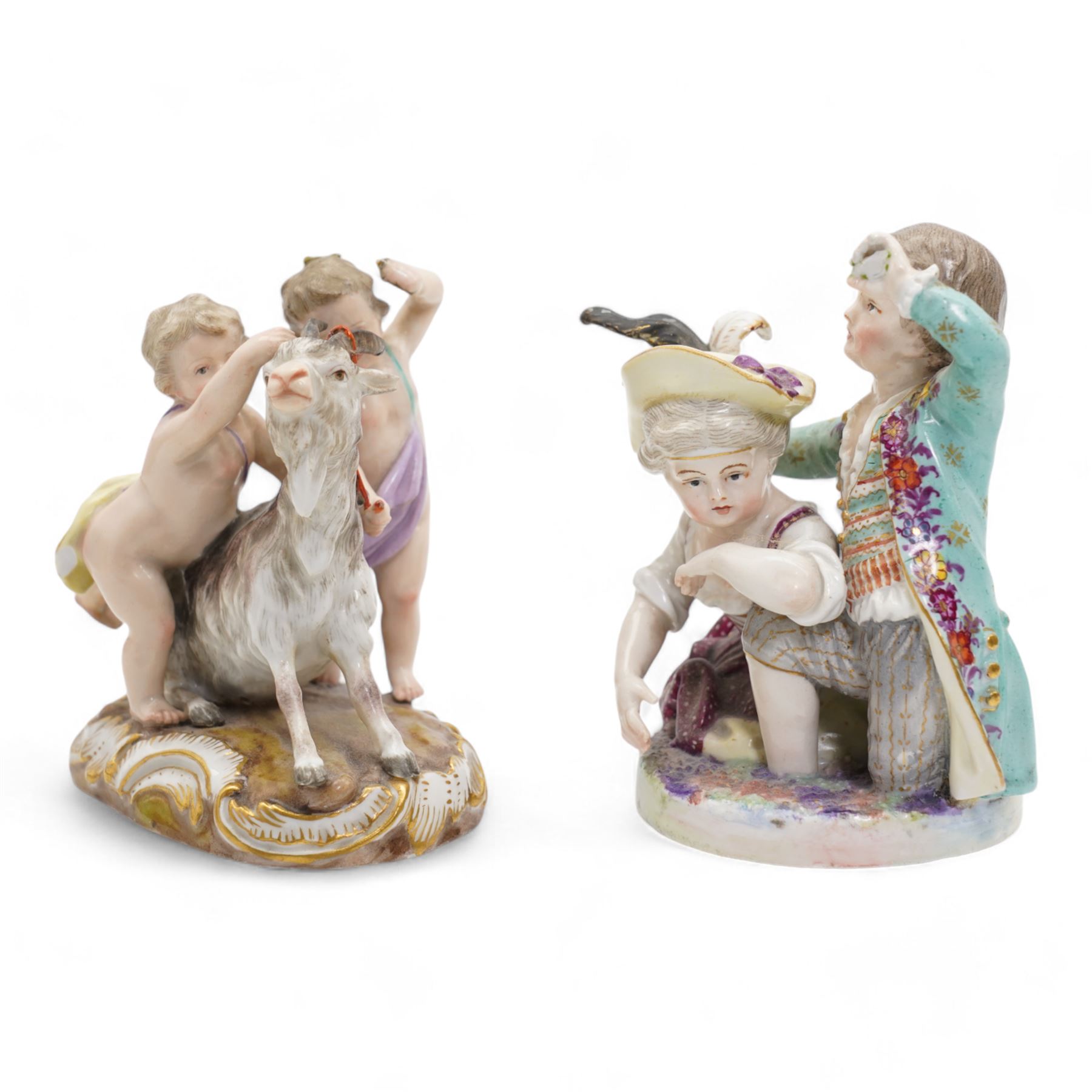 Meissen porcelain group modelled as two cherubs playing with a goat, the oval scroll moulded base heightened in gilt, blue crossed swords, inscribed no. 2454, H10cm, together with a Meissen figure of a young girl and boy, possibly emblematic of autumn, unmarked, (2) Provenance: From the Estate of the late Dowager Lady St Oswald