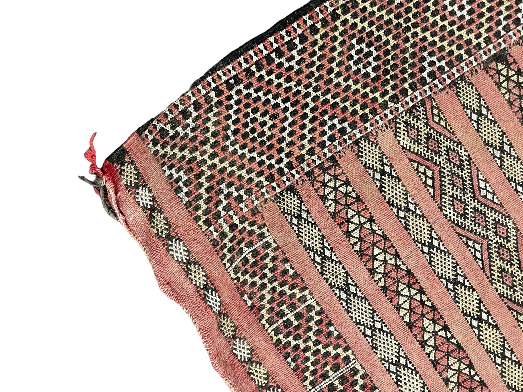 Moroccan Berber rug, pale red ground, decorated with horizontal geometric pattern bands, lozenge pattern upright bands