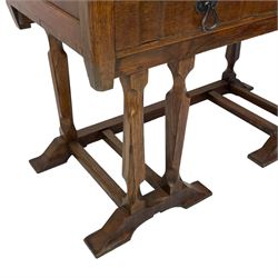 Arts & Crafts design oak chest on stand, rectangular top over two short and one long drawer, on a series of shaped and tapered supports with carved and beaded decoration, united by chamfered stretchers rails, on sledge feet 