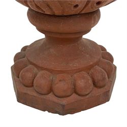 Pair of late 19th to early 20th century red terracotta garden urn planters, the shallow bowls moulded with curled acanthus leaf decoration, on circular foot with globular beaded moulding, octagonal base