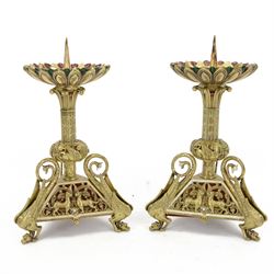 Pair of French brass candlesticks, the circular candle holder with red and green enamel de...