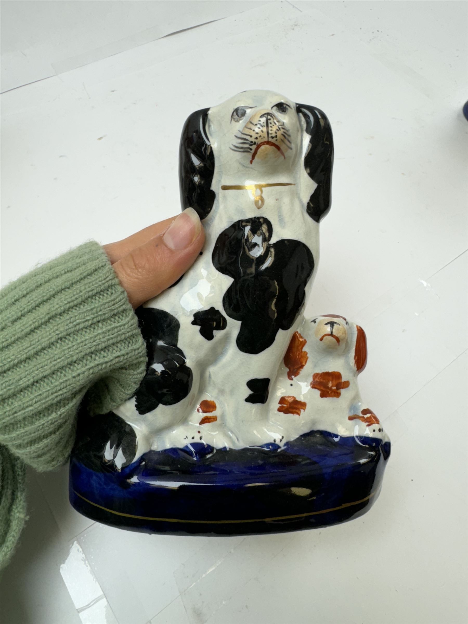 Pair of standing Staffordshire whippets with rabbits in their mouths, together with a pair of Staffordshire spaniels, whippets H30cm