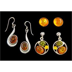 Pair of 14ct gold circular amber stud earrings, hallmarked and two pairs of silver amber pendant stud earrings, stamped 925