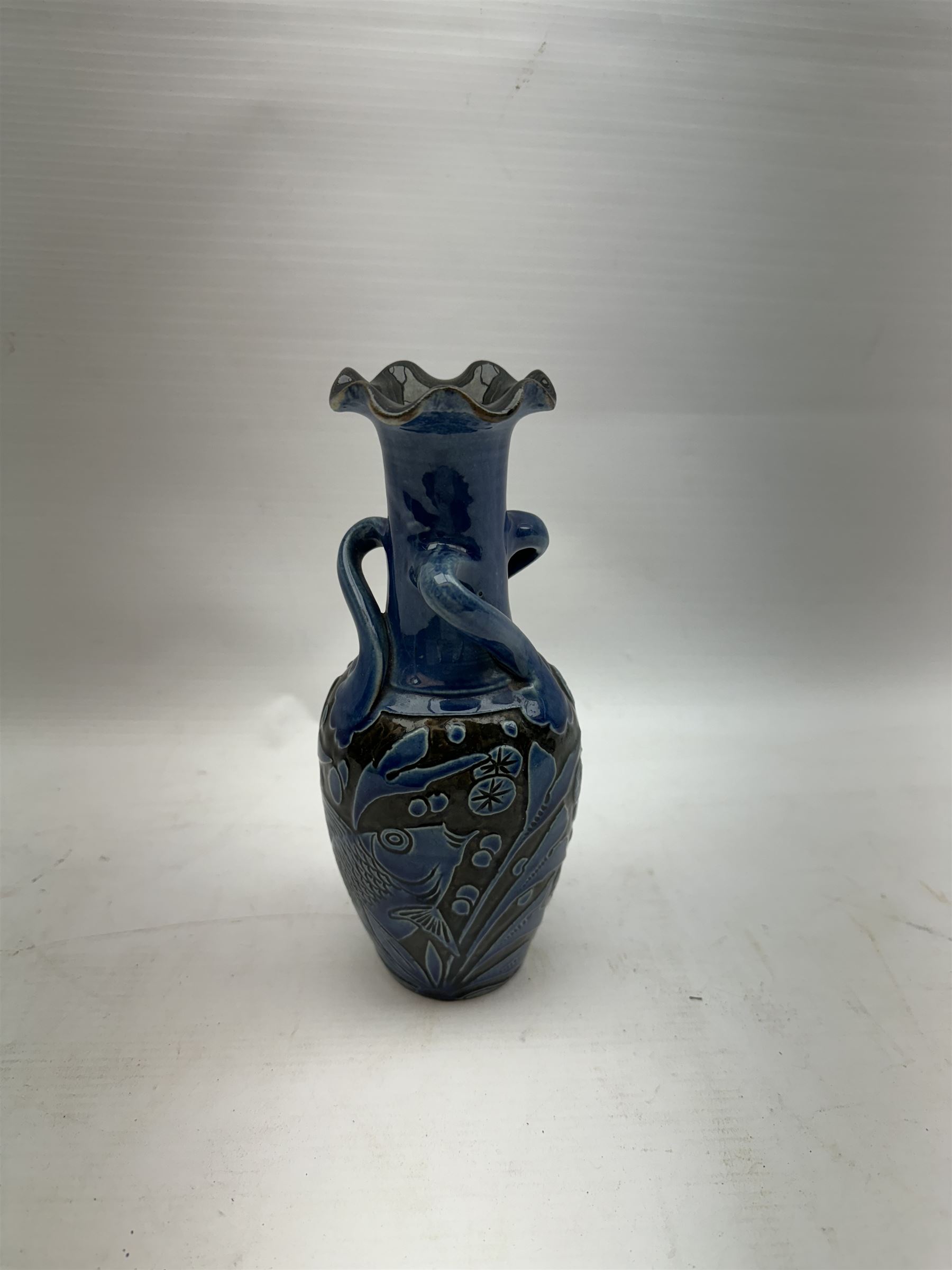 Alexander Lauder for Barum Pottery, vase of baluster form with fluted time, decorated in relief with fish upon a blue ground, H20cm