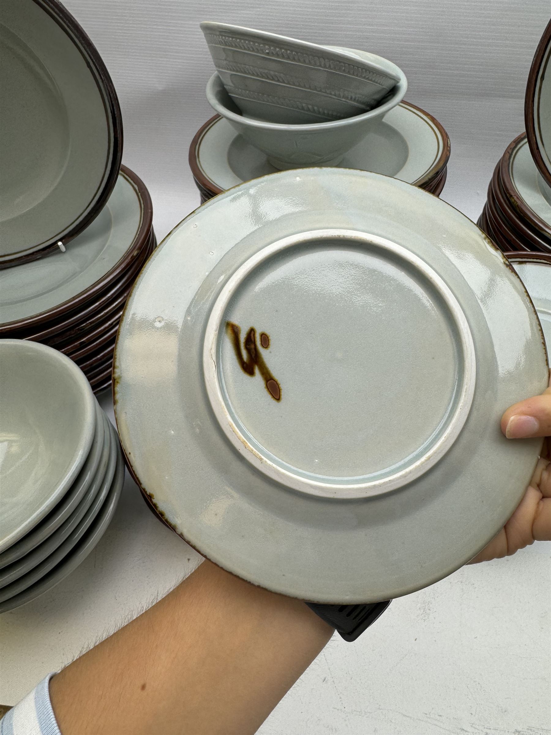 20th century celadon dinner service with iron rim, comprising nineteen dinner plates 26.5cm, twenty-four side plates D24cm, twelve varying bowls, twenty-two tea plates and fifteen saucers 