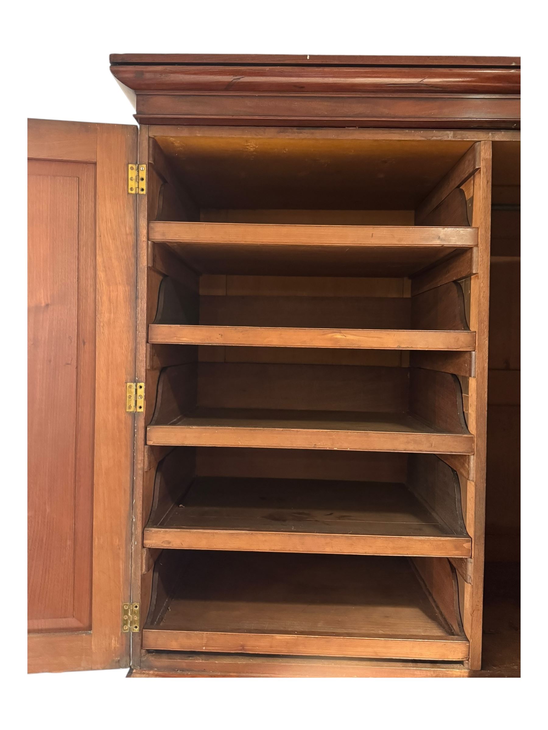 Victorian mahogany linen-press, moulded cornice over two figured panelled doors, the interior fitted with five slides and hanging rail, four long drawers below 