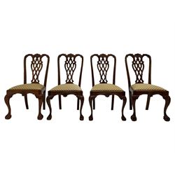 Set of twelve Chippendale design mahogany dining chairs, shaped cresting rail carved with foliage and C-scrolls, pierced interlaced splat with curled leaf decoration, upholstered drop-in seat, moulded seat rails, on scrolled acanthus carved cabriole supports with ball and claw feet 