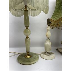 Onyx table lamp, with knopped stem and cream and green tassel shade, together with three smaller similar onyx lamps, classical style alabaster figures and a covered onyx jar