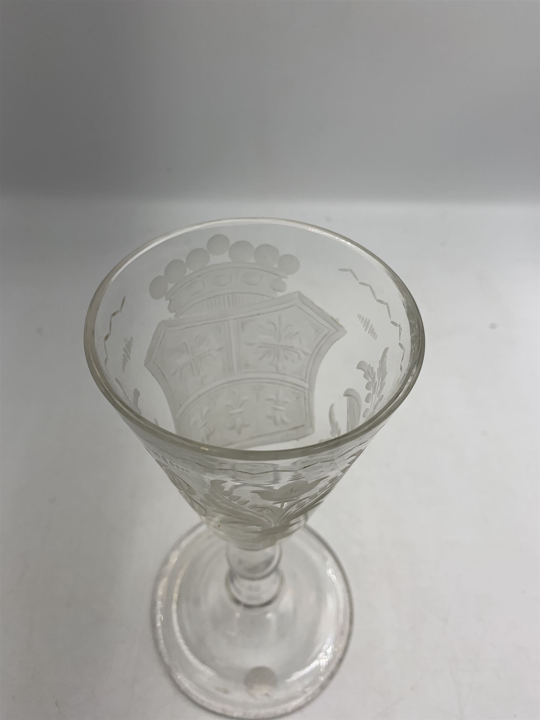 18th century large baluster wine glass, circa 1745, the funnel bowl decorated with a crest and foliate, to a knopped stem and deep domed  and upturned foot, H20cm