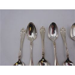 Two sets of twelve late 19th/ early 20th century American silver coffee spoons, the first set with engraved initial to terminal within scrolling border and engraved date verso, the second set with embossed floral decoration to handles, all stamped Sterling 