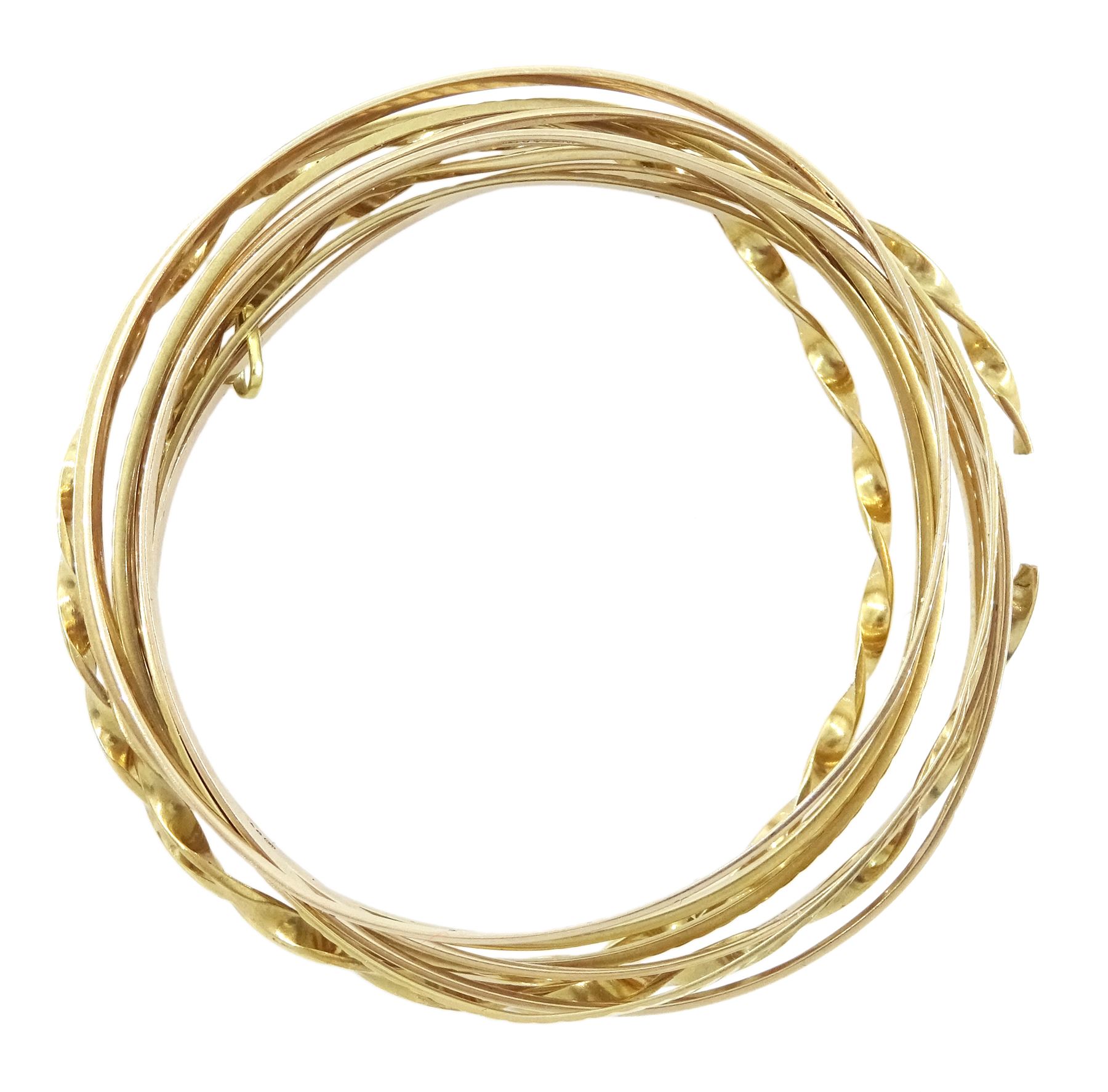 Ten 9ct gold bangles, hallmarked