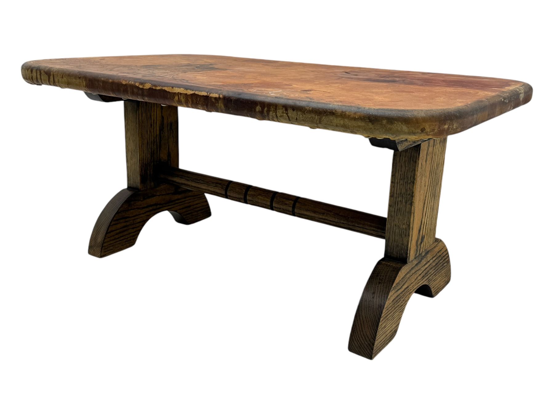 Rectangular oak coffee table, rectangular top with tan leather cover decorated with naturalistic scene, on rectangular end supports and curved feet united by turned stretcher 