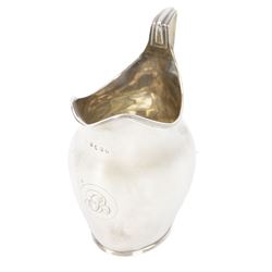 George III silver cream jug, of helmet form, with engraved monogram to body, hallmarked Lo...