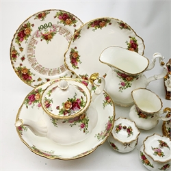 A Royal Old Country Roses teaset, comprising teapot, six teacups, six saucers, six side plates, milk jug, open sucrier, and cake plate, plus a large bowl, jug, pair of jars and covers, pair of photograph frames, 1980 calendar plate marked first edition, and five cloth napkins. 