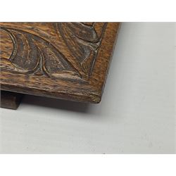 Arts and Crafts oak stand by Arthur Simpson of Kendal, of rectangular form with central hammered pewter panel, surrounded by a border with carved foliate corners, upon two bar supports, bearing label detailed 