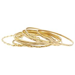 Ten 9ct gold bangles, hallmarked