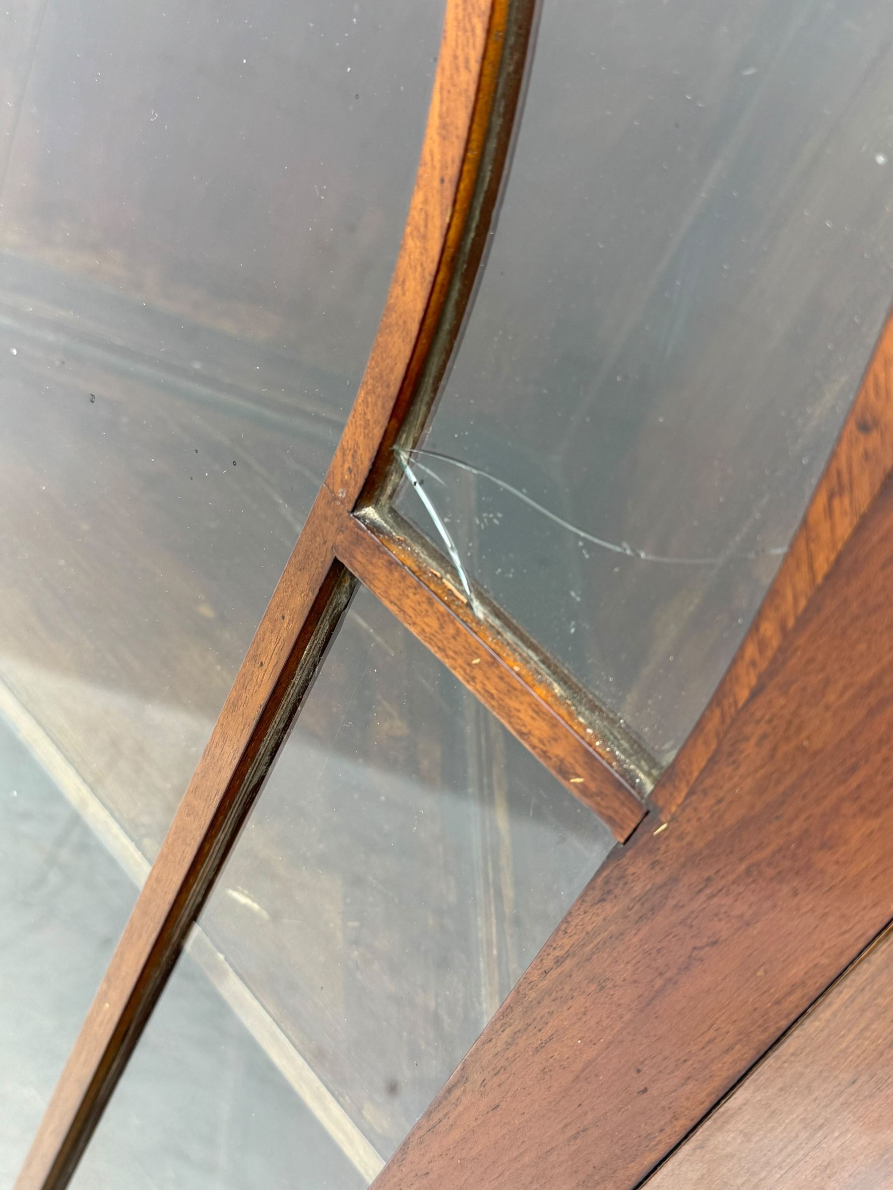 19th century mahogany floor-standing corner display cabinet, moulded cornice over blind fretwork frieze, enclosed by single astragal glazed door, the interior fitted with three shelves, on bracket feet