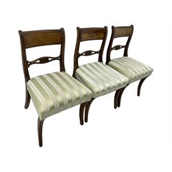 Set of six early 19th century mahogany dining chairs, bar cresting rail over pierced and shell carved middle rail, reed moulded uprights, upholstered seats on reed moulded sabre supports 