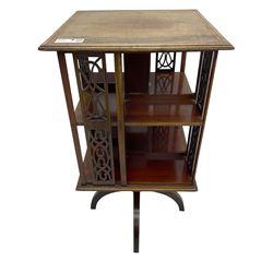 Edwardian mahogany revolving bookcase, square moulded top with satinwood band, two tiers with pierced vertical splats, on four curved supports 