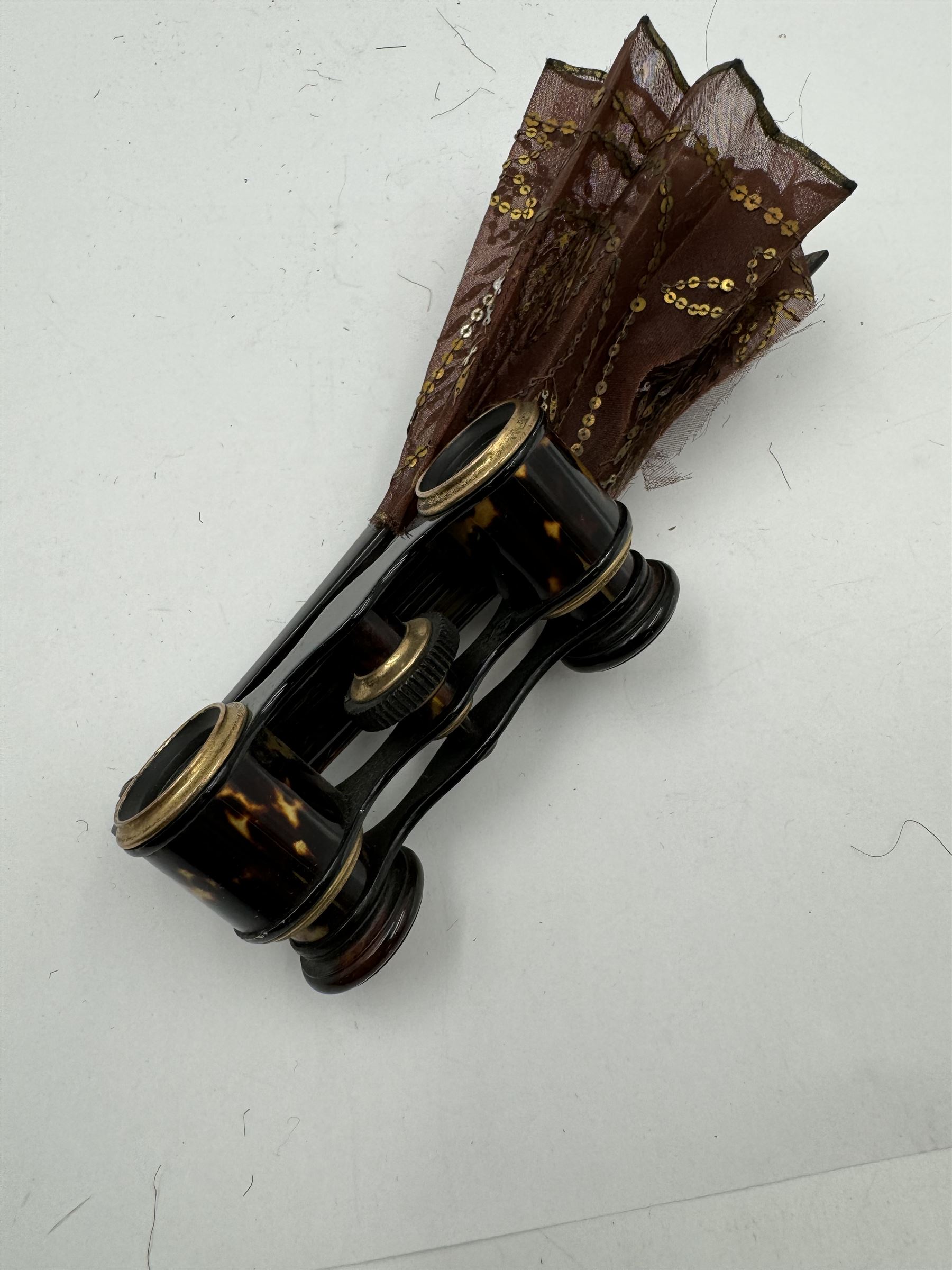 Early 20th century Asprey & Co opera glasses, with simulated tortoiseshell body and handle, the handle opening to reveal a chiffon fan, finely worked with sequins, stamped Asprey & Co London