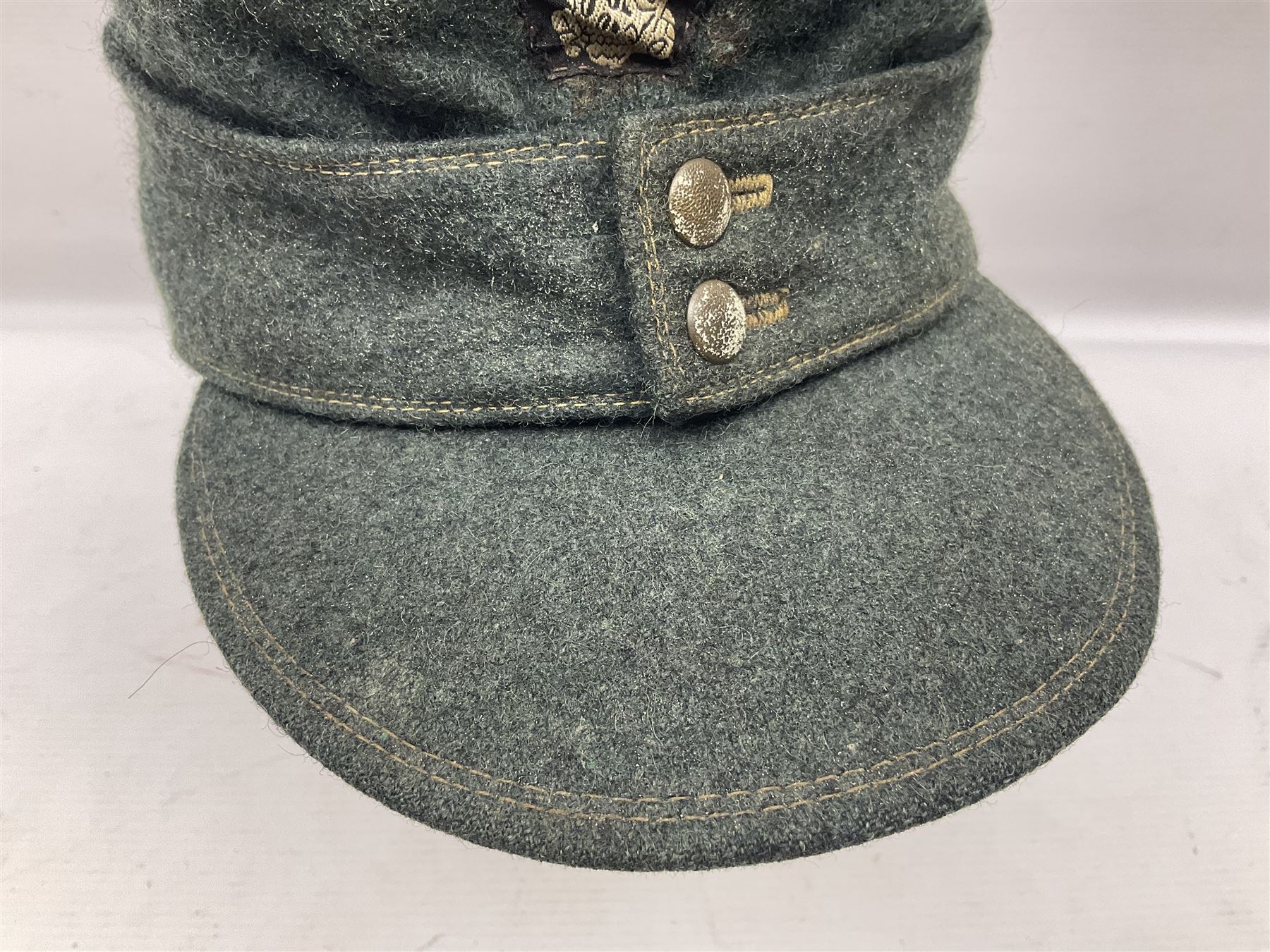 WWII German M43 field cap with 'SS' cloth badge and mountain trooper's ...