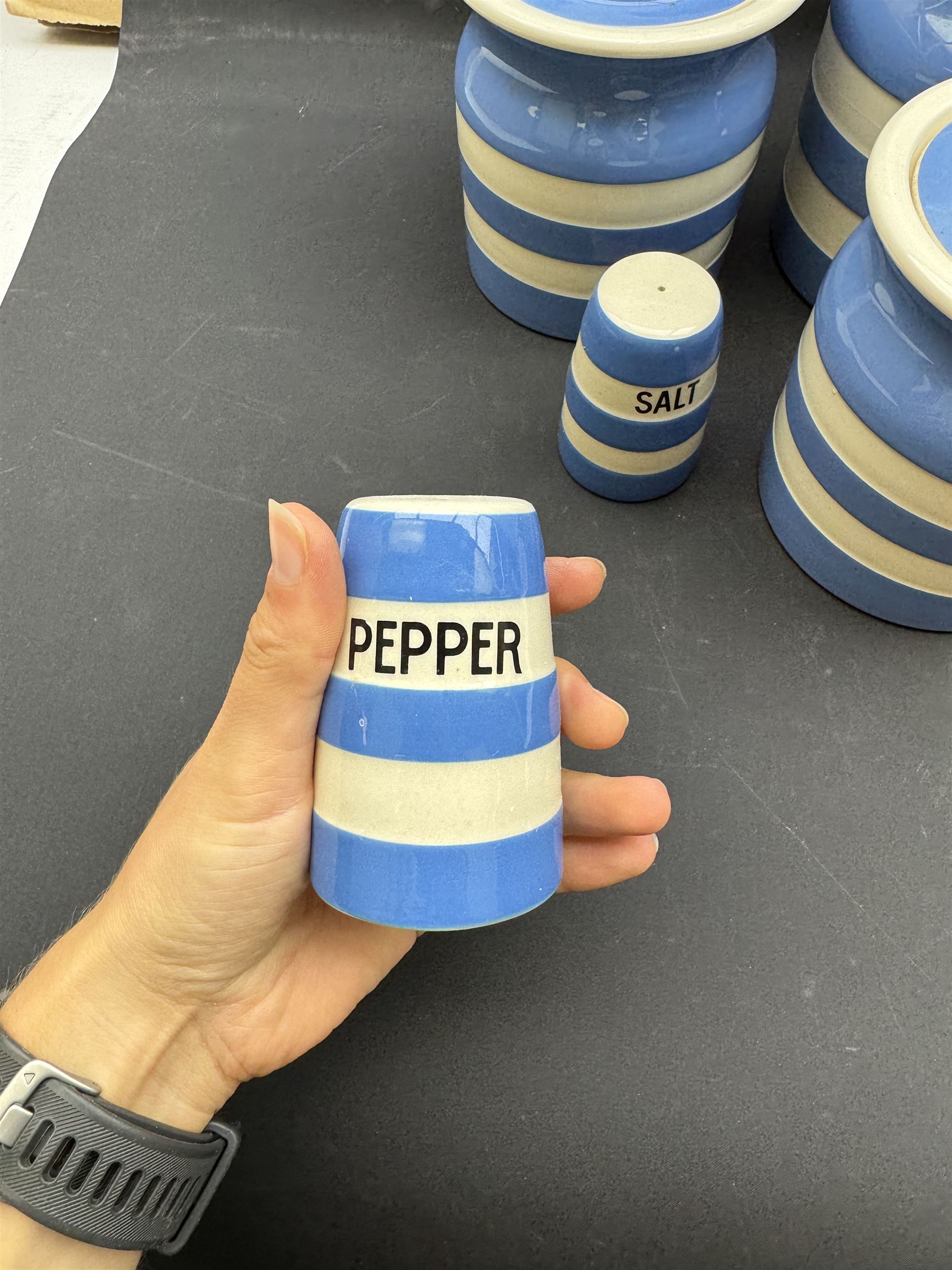 Three T G Green jars, together with salt and pepper shakers