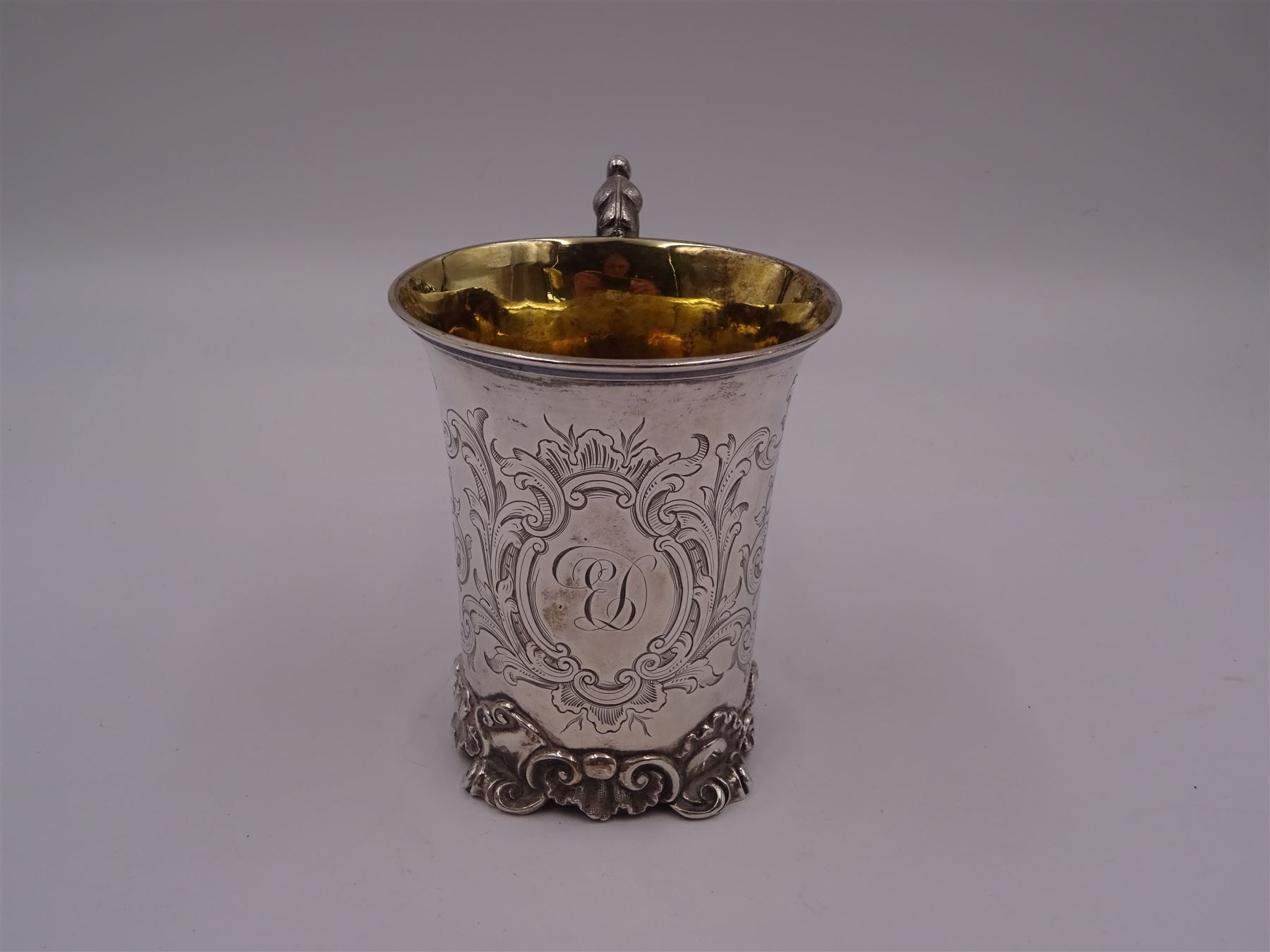 Victorian silver christening mug, of cylindrical form with fluted rim, gilt interior and acanthus capped C scroll handle, the body with later engraved decoration and initials, with embossed scroll base, hallmarked John Evans II, London 1840, including handle H10.2cm