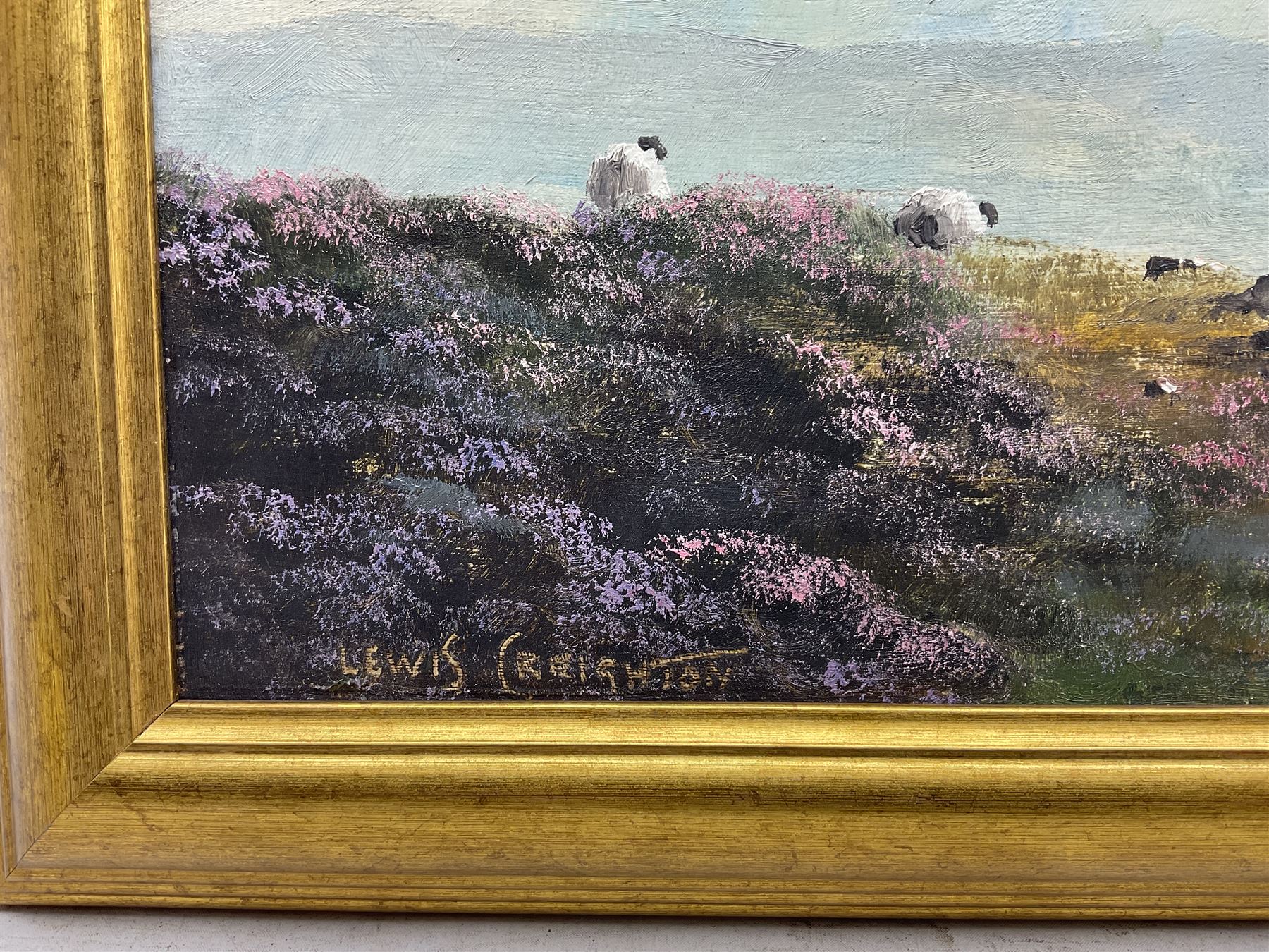 Lewis Creighton (British 1918-1996): Sheep Grazing Amongst Heather Moorland, pair oils on board signed 27cm x 64cm (2)