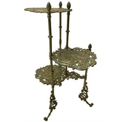 Cast gilt metal three-tier cake stand, each tier decorated with cast foliage scrolls and flower heads with a central bird motif, on turned and fluted supports with splayed C-scroll feet