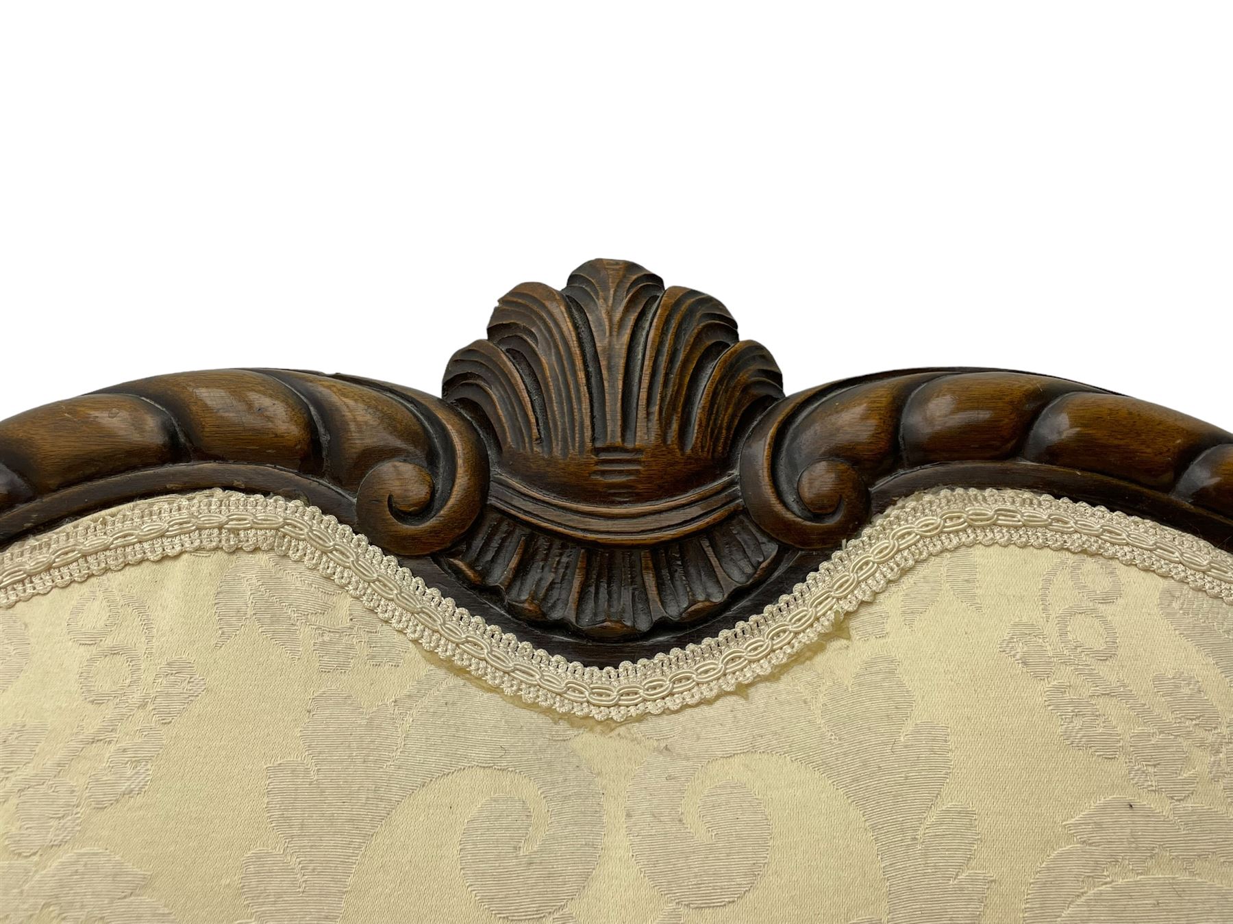 Victorian design walnut framed settee, shaped camelback with gadroon carved edge and central feather motif, upholstered in cream damask fabric with scrolling floral pattern, S-scroll arm facias carved with flower head and curled leaves, feather carved C-scroll splayed feet 