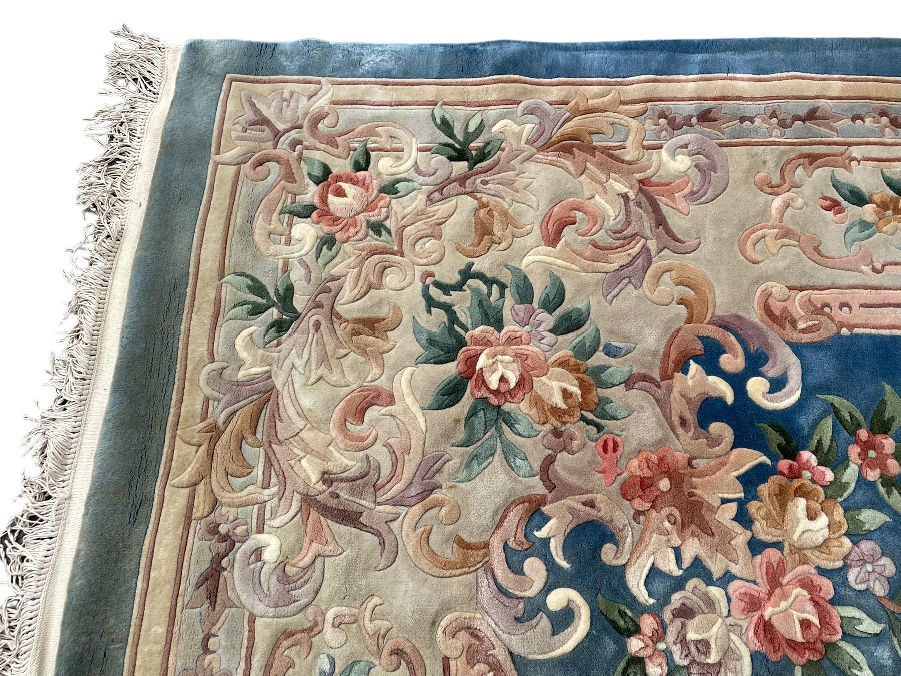 Large Chinese blue ground woollen carpet, overall floral design, central oval medallion surrounded by scrolling floral decoration, wide border with decorated with floral bouquets 