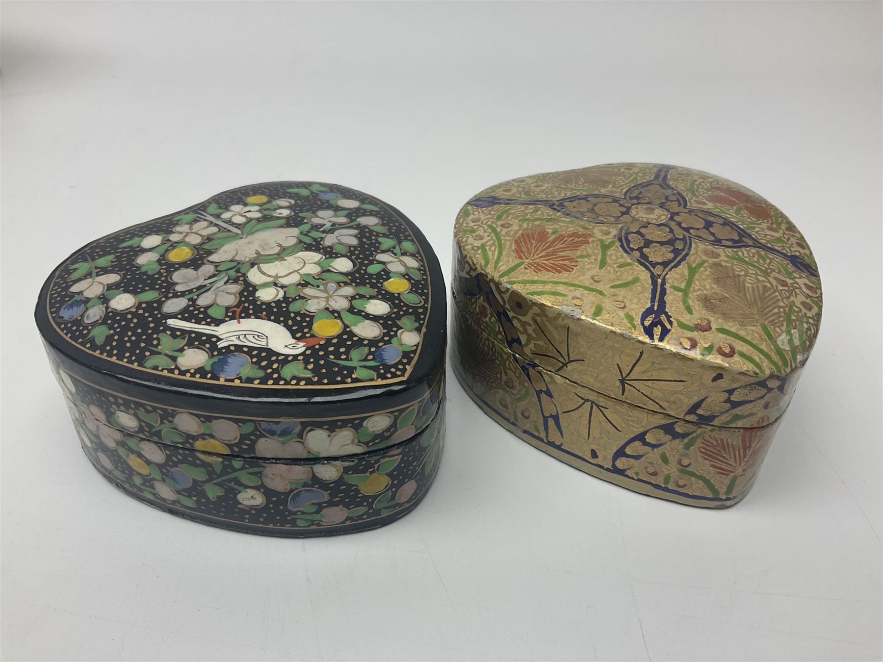 Nine lacquered boxes, including seven heart shaped examples, mainly decorated with floral designs, largest H12cm