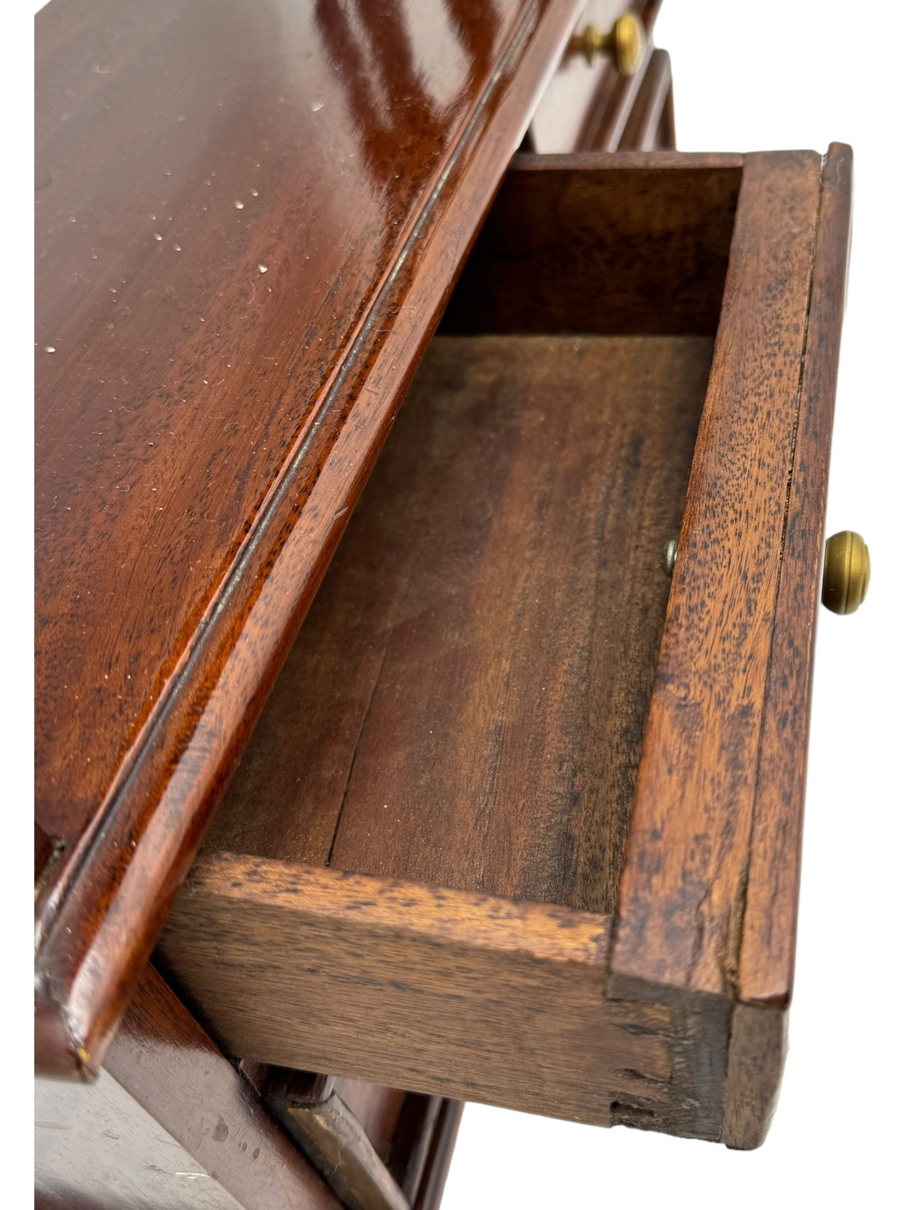 Georgian design mahogany open bookcase, fitted with three open shelves flanked by pierced uprights, with four drawers to the base with scalloped apron