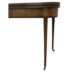 19th century mahogany tea table, fold-over top with reeded edge over inlaid frieze, on double gate-leg action square tapering supports, with brass castors