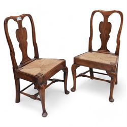 Pair of 18th century elm side chairs, shaped splat back over drop-in rush seat, on cabriole supports united by turned stretchers 