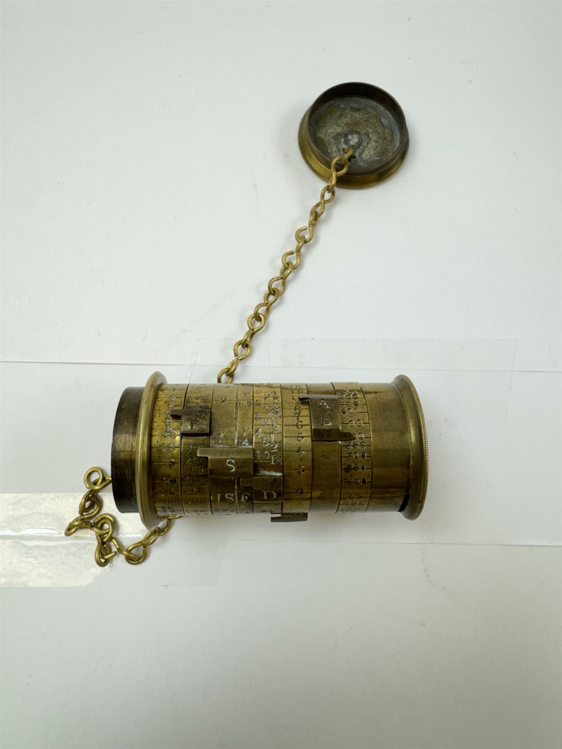 Late 19th century Watkins Exposure Meter, in cylindrical brass case, inscribed Sole Makers R. Field & Co, Birmingham, together with a 19th century brass plate camera lens