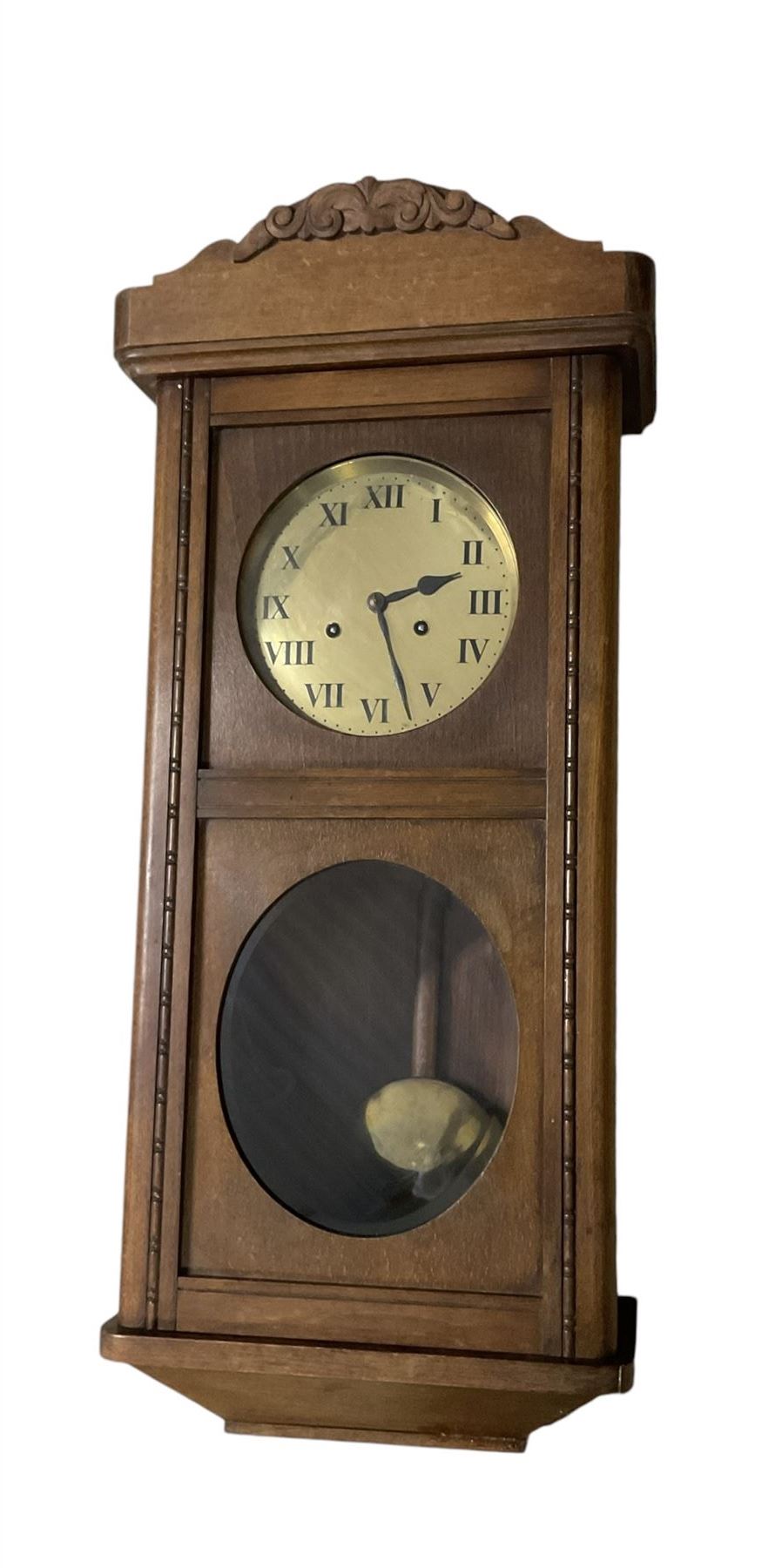 Two train oak cased wall clock, striking the hours on a coiled gong. With pendulum and key.