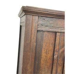 17th century and later oak hall cupboard, panelled front and sides with moulded frame, enclosed by single door with wrought metal hinges and handle, the interior fitted with hooks, on stile supports 